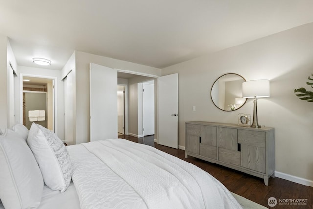 bedroom with dark wood-style floors and baseboards