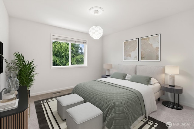 carpeted bedroom featuring baseboards and visible vents