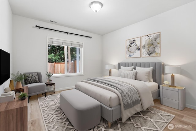 bedroom featuring light wood-style floors, baseboards, and visible vents