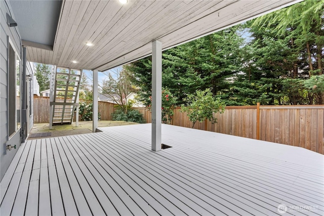 wooden deck with a fenced backyard and stairs