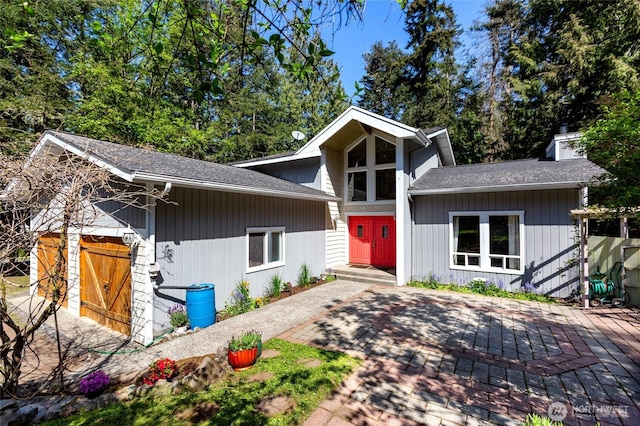 mid-century inspired home with a patio area and roof with shingles