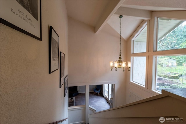 stairway featuring wood finished floors, a notable chandelier, high vaulted ceiling, and beamed ceiling
