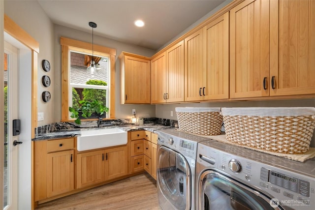 laundry area with cabinet space, separate washer and dryer, light wood-style flooring, and recessed lighting
