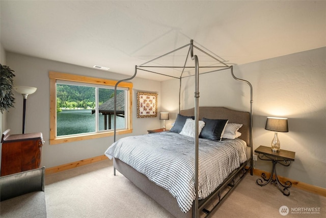 carpeted bedroom featuring baseboards