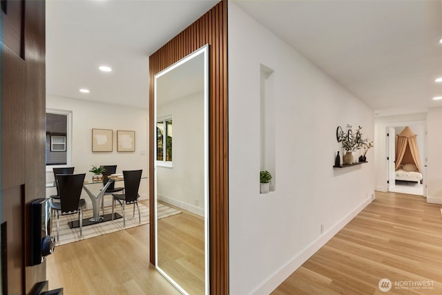 hall featuring recessed lighting, baseboards, and light wood finished floors