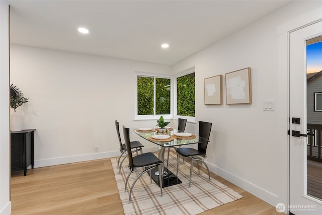 dining room featuring light wood-style floors, baseboards, and recessed lighting