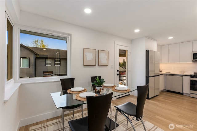 dining space featuring baseboards, recessed lighting, and light wood-style flooring