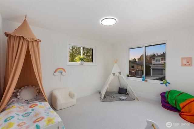 carpeted bedroom with baseboards and multiple windows
