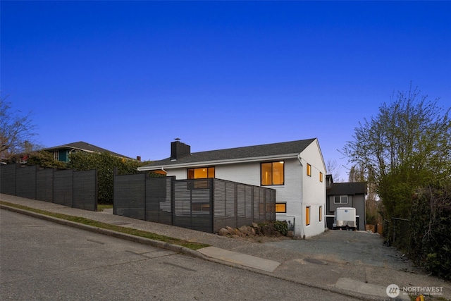 exterior space with fence and a chimney
