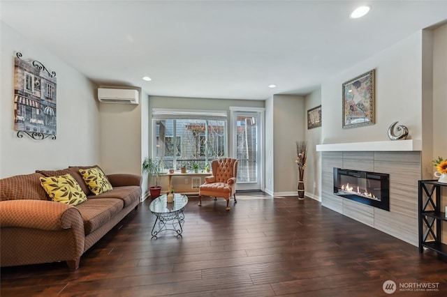 19225 Damson Rd Unit J2, Lynnwood, WA 98036 - living area with baseboards, a wall mounted air conditioner, a tiled fireplace, recessed lighting, and wood finished floors