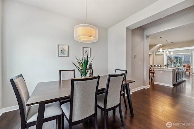19225 Damson Rd Unit J2, Lynnwood, WA 98036 - dining room featuring baseboards and dark wood finished floors