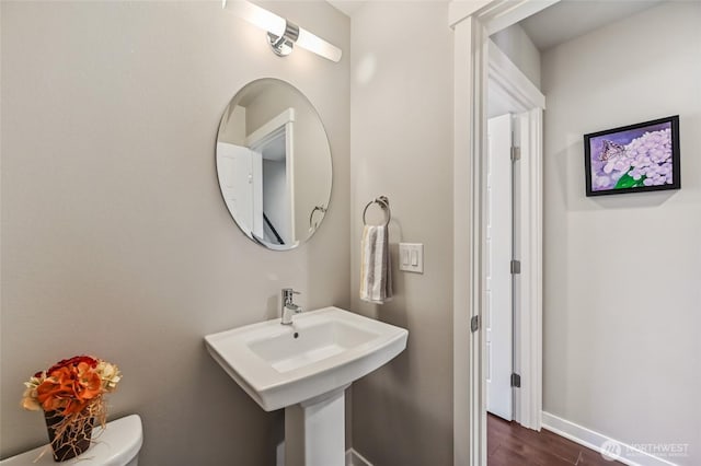 19225 Damson Rd Unit J2, Lynnwood, WA 98036 - bathroom featuring baseboards, toilet, and wood finished floors