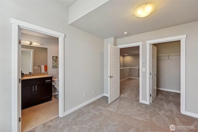 19225 Damson Rd Unit J2, Lynnwood, WA 98036 - unfurnished bedroom with ensuite bath, a spacious closet, light carpet, a sink, and baseboards