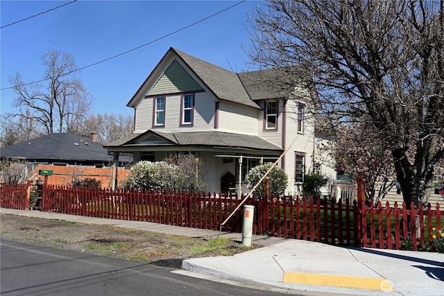 1321 Chestnut St, Milton-Freewater, OR 97862 - victorian home featuring a porch, a fenced front yard, and roof with shingles