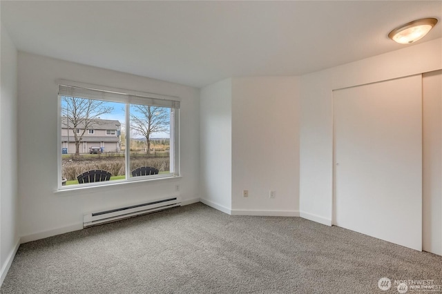 24762 45th Ave S Unit 12-D1, Kent, WA 98032 - unfurnished bedroom with a baseboard heating unit, carpet, baseboards, and a closet