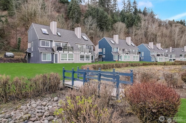 24762 45th Ave S Unit 12-D1, Kent, WA 98032 - back of property featuring a balcony, a yard, a chimney, roof with shingles, and a residential view