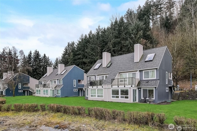 24762 45th Ave S Unit 12-D1, Kent, WA 98032 - rear view of property with roof with shingles, a chimney, a balcony, and a lawn