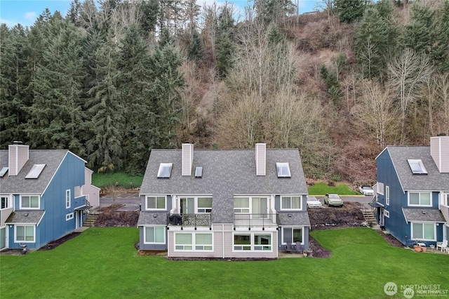 24762 45th Ave S Unit 12-D1, Kent, WA 98032 - rear view of property with a chimney, roof with shingles, a balcony, and a yard