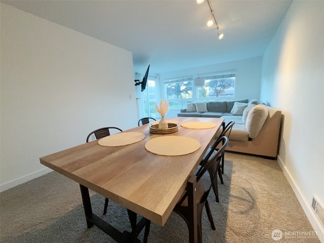 24762 45th Ave S Unit 12-D1, Kent, WA 98032 - dining room with light carpet, rail lighting, and baseboards
