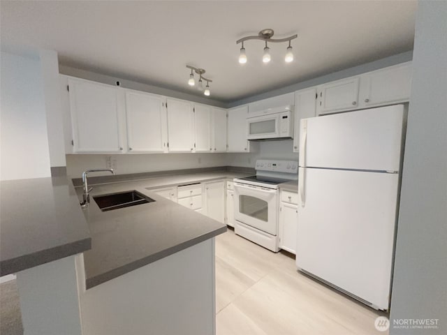 24762 45th Ave S Unit 12-D1, Kent, WA 98032 - kitchen featuring white appliances, a sink, a peninsula, and white cabinets