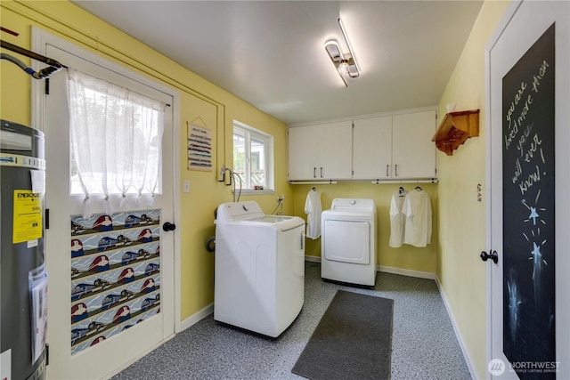 washroom featuring baseboards, cabinet space, and washing machine and dryer