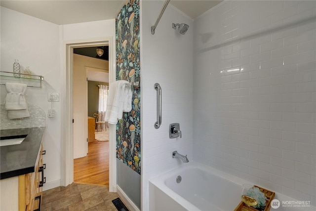 full bathroom with stone finish flooring, visible vents, shower / bath combination with curtain, baseboards, and vanity