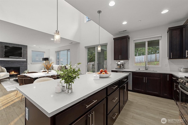 7872 198th Avenue Pl E, Bonney Lake, WA 98391 - kitchen featuring a sink, open floor plan, light countertops, light wood finished floors, and stainless steel gas stove