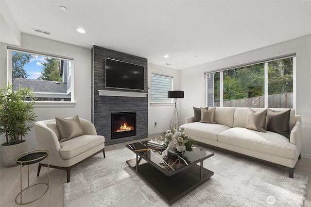 7872 198th Avenue Pl E, Bonney Lake, WA 98391 - living room with wood finished floors, plenty of natural light, a fireplace, recessed lighting, and baseboards