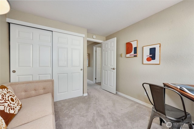 office with baseboards and light carpet