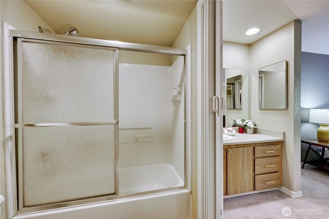 bathroom with vanity and shower / bath combination with glass door
