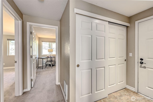 entryway featuring baseboards and visible vents