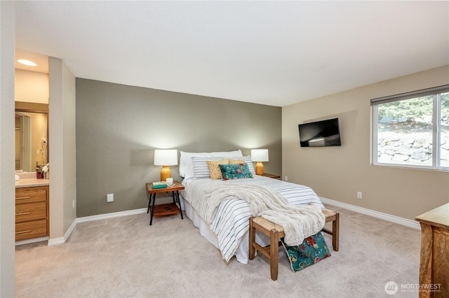 bedroom featuring baseboards and light colored carpet