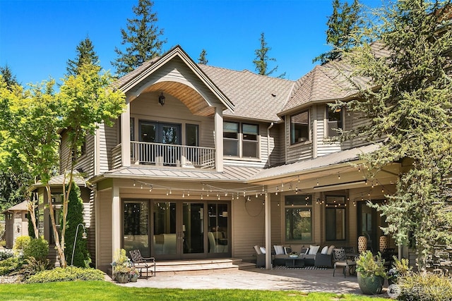 back of house featuring outdoor lounge area, a patio, french doors, and a balcony