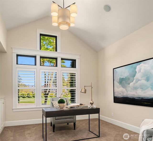 carpeted office featuring lofted ceiling and baseboards