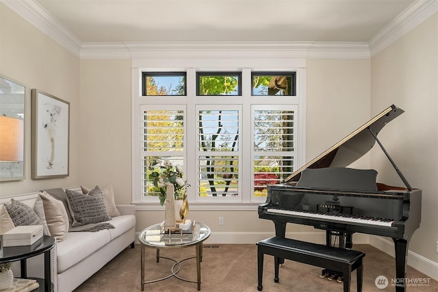 living area with baseboards, a healthy amount of sunlight, and crown molding