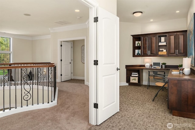 office area featuring recessed lighting, built in study area, baseboards, ornamental molding, and light colored carpet