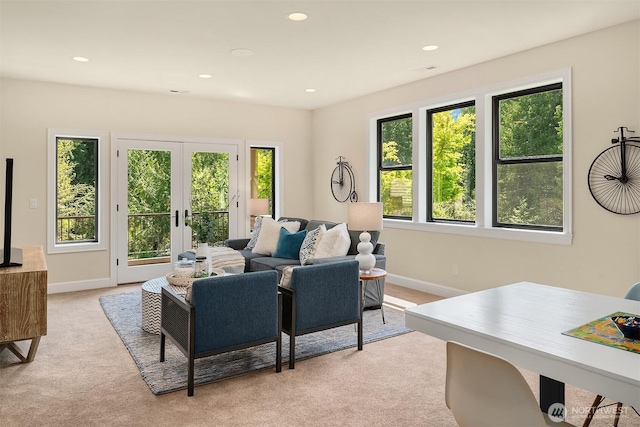 living area with recessed lighting, light carpet, french doors, and baseboards