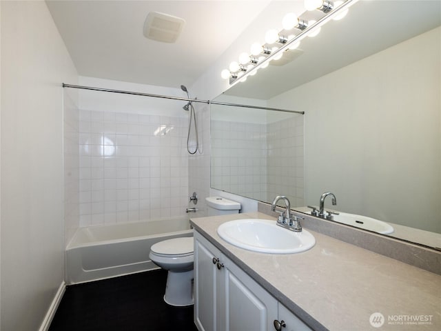 bathroom with visible vents, toilet, vanity, wood finished floors, and shower / bath combination