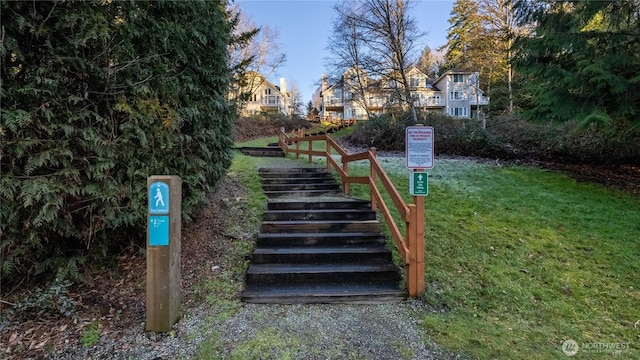view of community featuring stairway and a lawn