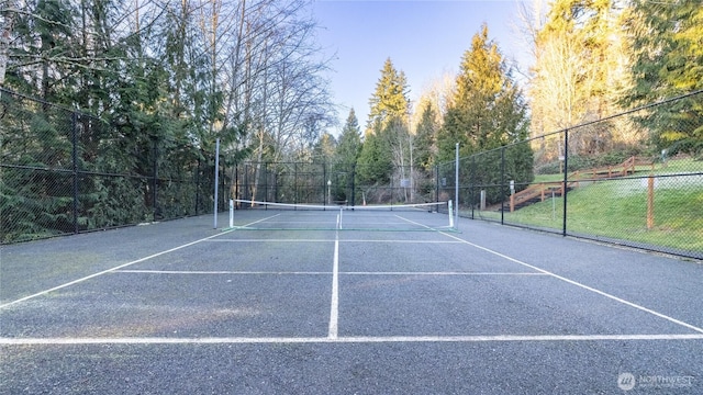 view of tennis court with fence