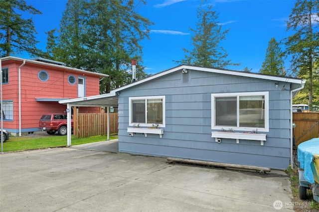 view of home's exterior featuring fence
