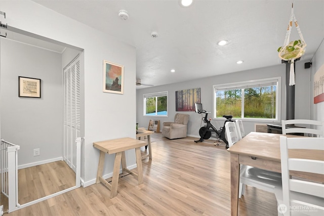 dining space featuring light wood-style floors, baseboards, and recessed lighting