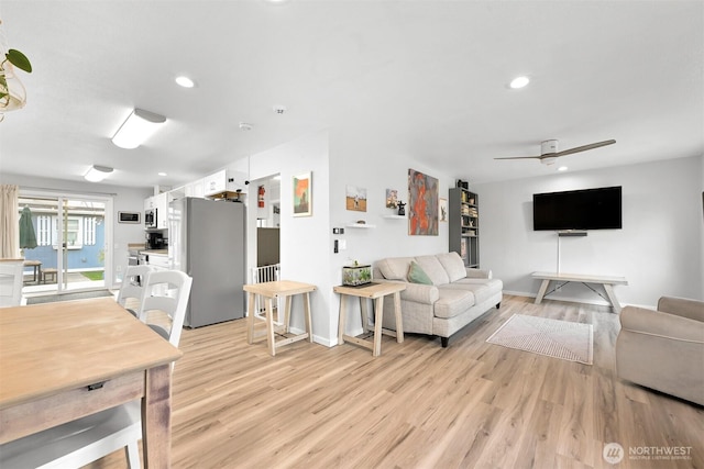 living room featuring recessed lighting, light wood-style flooring, baseboards, and ceiling fan