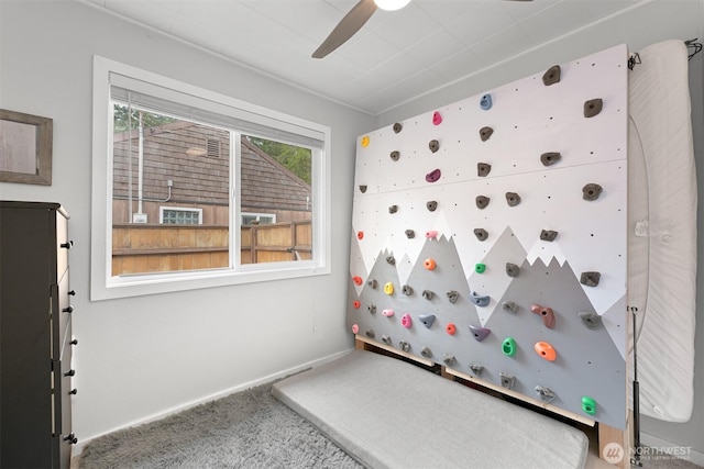 unfurnished bedroom featuring carpet flooring, baseboards, and ceiling fan