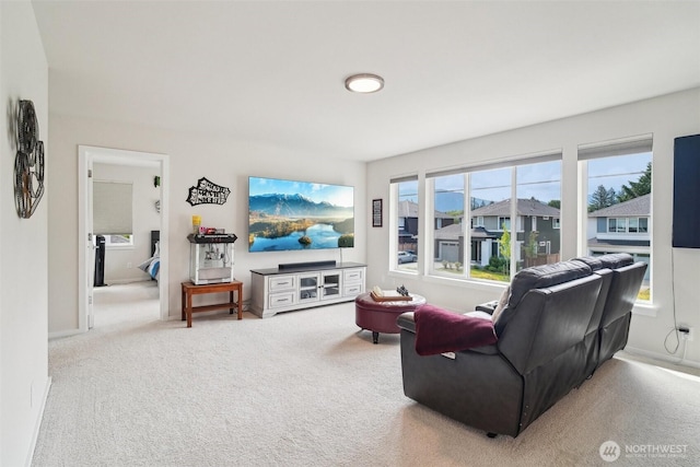 living area featuring carpet flooring and baseboards