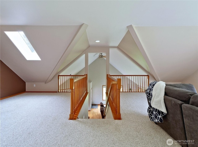bonus room featuring vaulted ceiling with skylight, carpet flooring, and ceiling fan