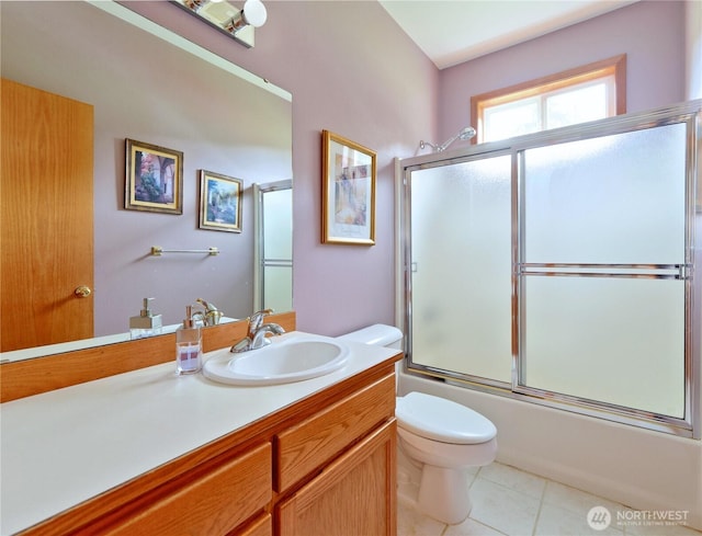 full bath featuring shower / bath combination with glass door, vanity, toilet, and tile patterned flooring
