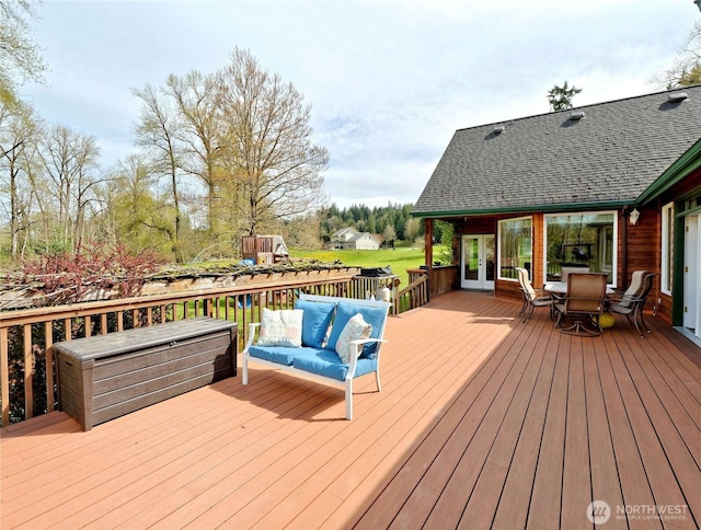 deck featuring french doors and outdoor lounge area