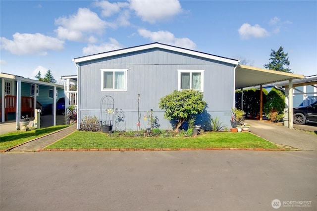 31600 126th Ave SE Unit 114, Auburn, WA 98092 - view of side of property featuring a carport, a lawn, and driveway
