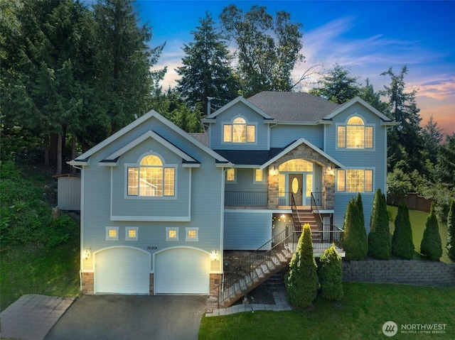 36984 Aspen Way NE, Hansville, WA 98340 - view of front of property featuring stairs, stone siding, covered porch, an attached garage, and asphalt driveway